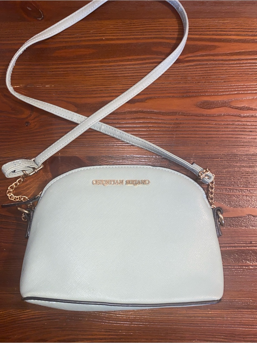 Christian Siriano dome crossbody gold-tone chain strap & metallic logo hardware.